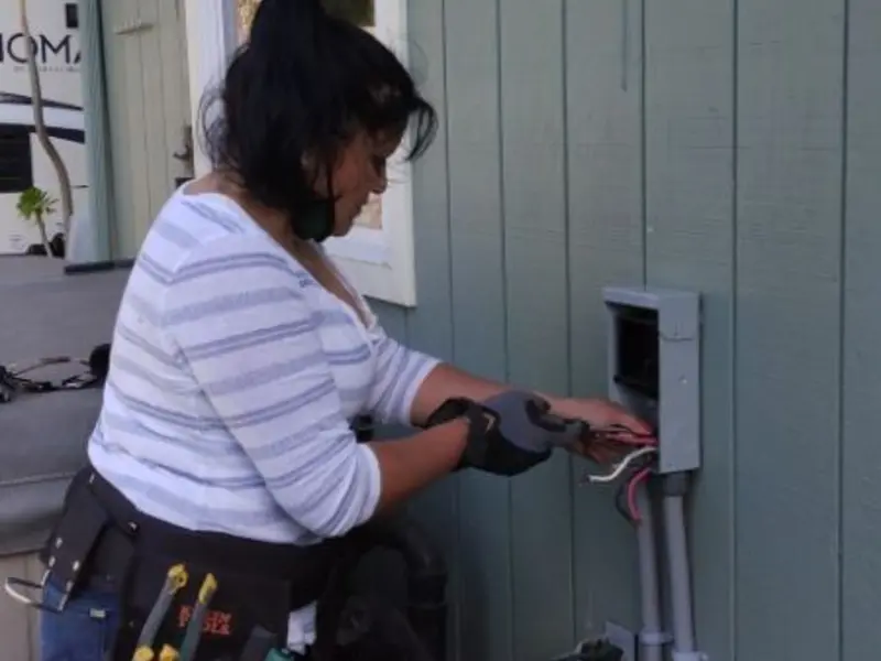 Licensed electrician wiring an exterior subpanel in New Square